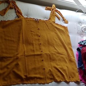 A mustard yellow button down spaghetti shirt